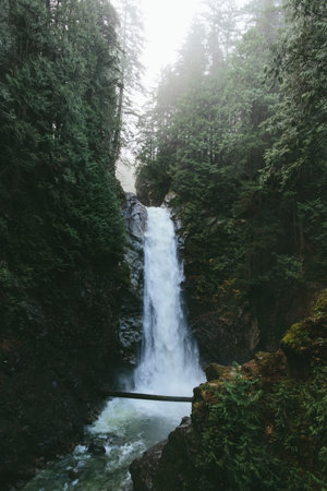 A stunning view of a waterfall surrounded by rocks during sunset.