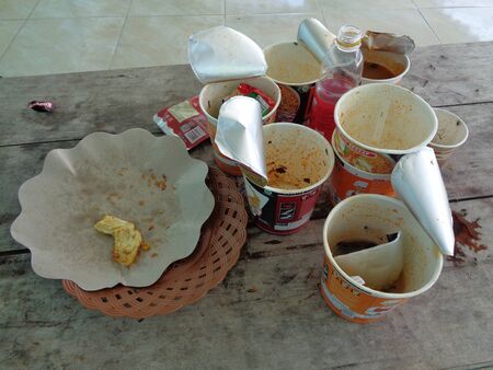 Kediri, Melta Waterland, East Java, Indonesia - November 1st, 2019 : straggle rubbish on the table that contain plate, paper, cup, plastic, and coffeeのeditorial素材