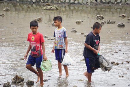 People fishing on gropyok iwak. Gropyok iwak means festival fishing together using traditional toolsのeditorial素材