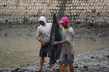 People fishing on gropyok iwak. Gropyok iwak means festival fishing together using traditional tools