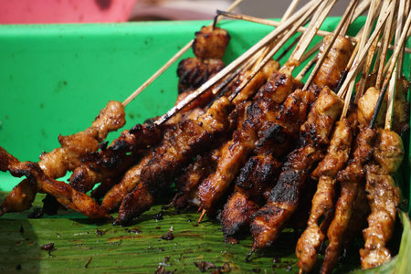 Indonesian roasting sate. Sate is one of traditional Indonesian food served with peanut sauce