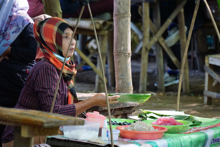 Kediri, East Java, Indonesia - December 12th, 2021 : People buy food on Pasar ndeso Sor Preng Mojo. Pasar ndeso means a traditional market that sells Indonesian traditional snacksのeditorial素材
