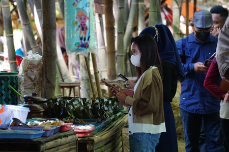 Kediri, East Java, Indonesia - December 12th, 2021 : People buy food on Pasar ndeso Sor Preng Mojo. Pasar ndeso means a traditional market that sells Indonesian traditional snacksのeditorial素材