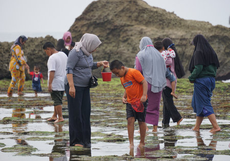 People vacation on mesra beach. Mesra means intimate. Mesra beach also known as kukup beach or ngrawe beachのeditorial素材