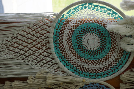 A handmade macrame wall decoration on the wall.