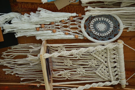 A handmade macrame wall decoration on the wall.