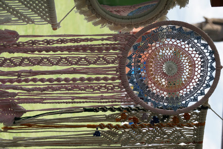 A handmade macrame wall decoration on the wall.