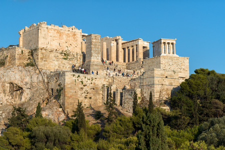 Athens, Greece - August 28, 2016: Visitors at the main entrance to Acropolis of Athens. You can appraise the dimensions of the old building.のeditorial素材