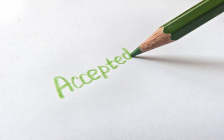 A pencil writes the word "Accepted"の写真素材