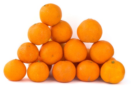 Pyramid made of several tangerines on white background の写真素材