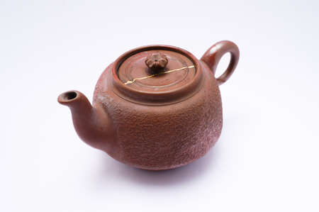 Kintsugi antique teapot. Gold cracks restoration on old Japanese pottery restored with the antique restoration technique.の写真素材