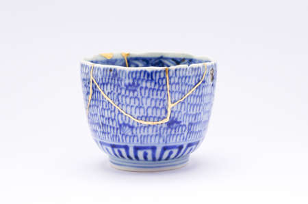 Kintsugi soba cup. Gold cracks restoration on old Japanese pottery restored with the antique restoration technique The unique beauty of imperfections.の写真素材