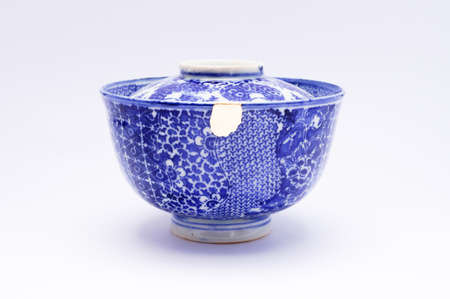 Kintsugi pottery. Gold cracks restoration on old Japanese pottery restored with the antique Kintsugi restoration technique. The beauty of imperfections.の写真素材