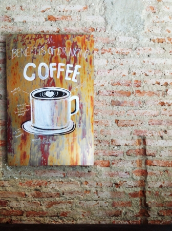 Old coffee advert painted on a brick wall.の素材