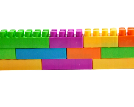 Toy colorful plastic blocks isolated on white backgroundの写真素材