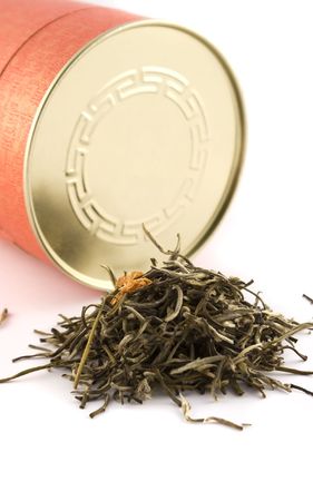 Green tea leafs with jasmine and red bottleの写真素材