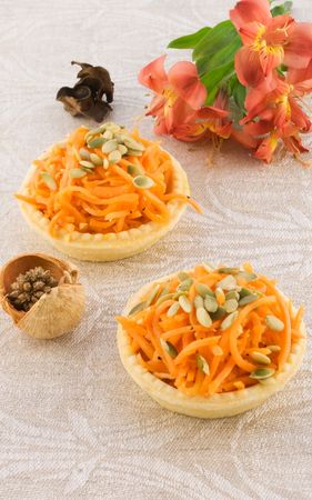 Carrot salad in a basket with flowerの写真素材