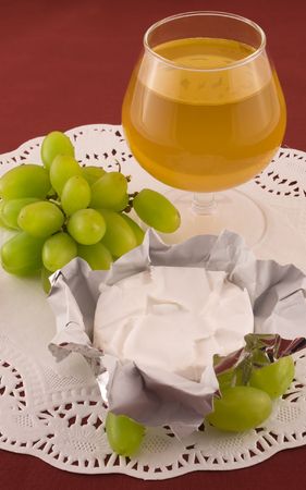 Fresh  grapes and cheese with white mold, white wineの写真素材