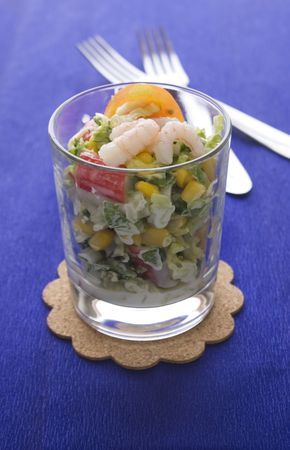 Fresh salad with crabsticks on black plateの写真素材