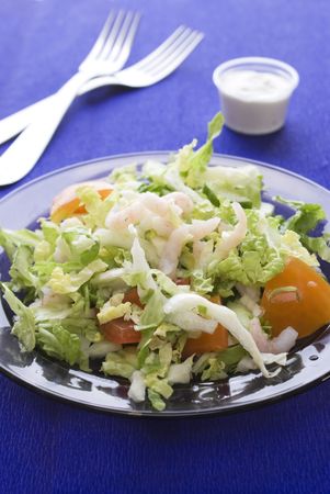 Fresh salad with shrimp and tomato on plateの写真素材