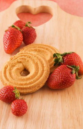 Fresh strawberries with cookies on wooden boardの写真素材
