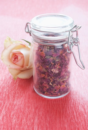 Dried rose petals in a jar with roseの写真素材