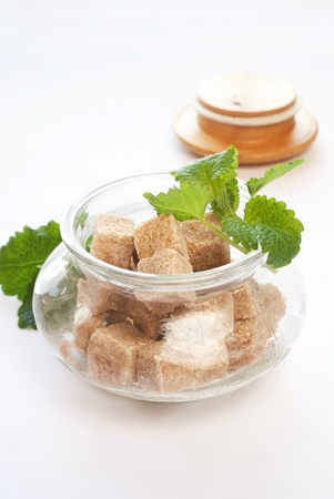 brown sugar in glass bowl with fresh herbsの写真素材