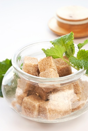 brown sugar in glass bowl with fresh herbsの写真素材