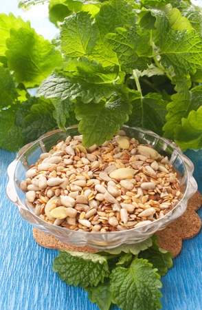 seeds in glass bowl with fresh herbsの写真素材