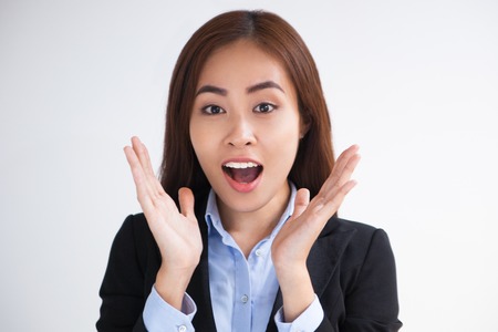 Surprised Asian woman with open mouth looking at camera. Excited happy businesswoman screaming....