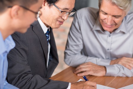 Experienced Asian man arranging merger dealの写真素材