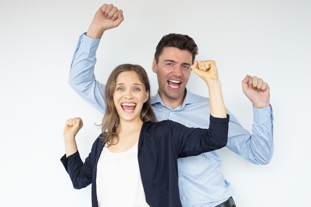 Cheerful Man and Woman Celebrating Successの写真素材