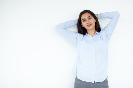 Relaxing Indian woman with hands behind headの写真素材