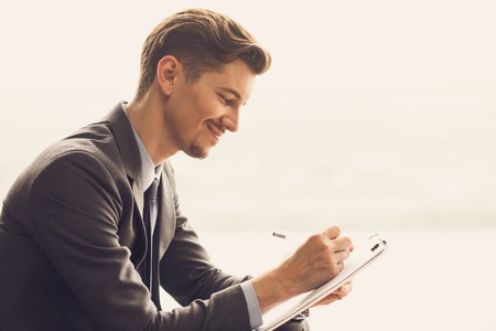 Content Middle-aged Businessman Making Notesの写真素材