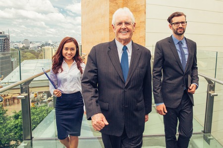 Senior Business Leader with Assistants on Bridgeの写真素材