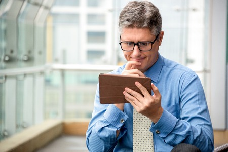 Business Man Using Tablet and Thinking Deepの写真素材