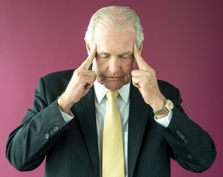Senior Boss Touching Temples and Thinking Deepの写真素材