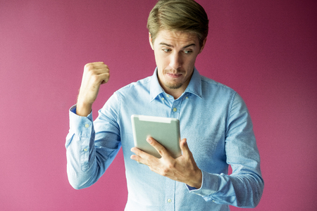 Confident businessman looking at digital tabletの写真素材