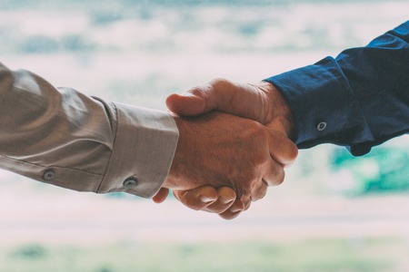 Closeup of Two Businessmen Shaking Handsの写真素材