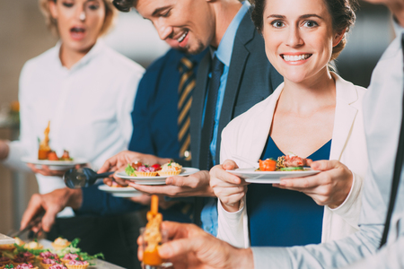 Smiling Business People and Snacks at Buffet Tableの写真素材