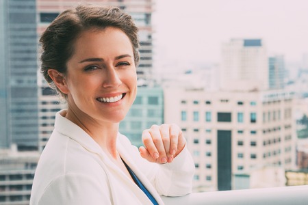 Closeup of Smiling Adult Businesswoman on Balconyの写真素材