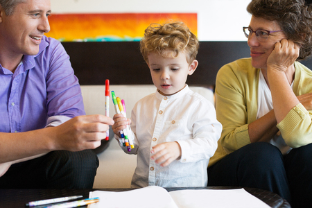 Grandmother, Father and Kid Holding Felt-tip Pensの写真素材