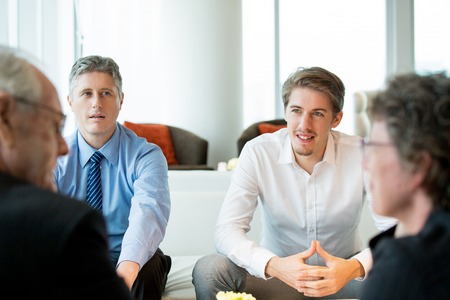 Four Business People Discussing Contract Termsの写真素材