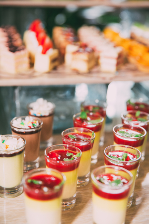Sweet Desserts in Shot Glasses on Buffet Tableの写真素材