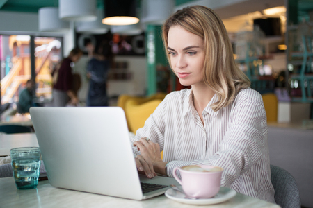 Concentrated female freelancer in co-working spaceの写真素材