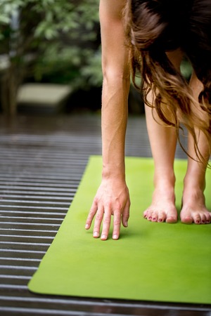 Close-up of woman bending to touch ground