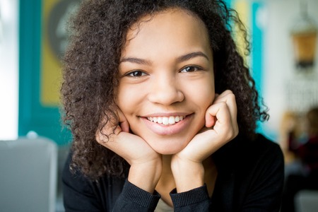 Close-up of smiling female face looking at cameraの写真素材