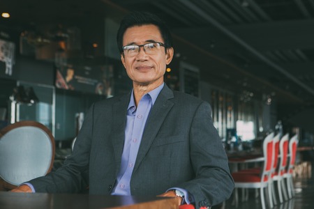 Middle-aged Asian Businessman in Restaurantの写真素材