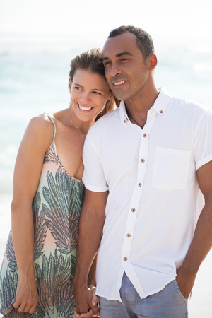 Dreamful couple holding hands at seaの写真素材