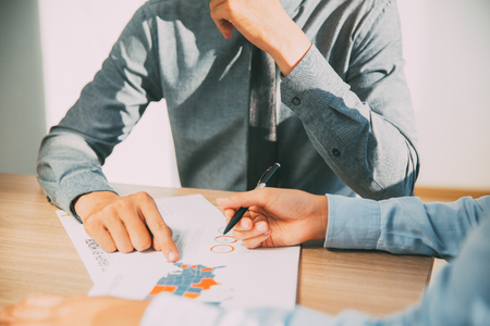 Businessman pointing at financial reportの写真素材